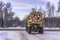 Transportation of logs on truck on forest road in winter