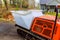 Transporting concrete on construction sites using a self dumping rubber track
