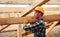 Transporting wooden boards. Construction worker in uniform and safety equipment have job on building