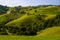 Transylvania landscape in the summer time with mountains and haystacks, mountain village in Romania