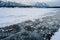 Trapped methane bubbles frozen into the water under the thick cracked and folded ice on Abraham Lake, located in the Kootenay