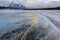 Trapped methane bubbles frozen into the water under the thick cracked and folded ice on Abraham Lake, located in the Kootenay