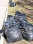 Trash bags filled with litter on roadside lawn