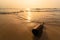 .Trash the beer bottle on the beach with sea waves at morning sunrise.Thailand