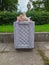 trash can filled with rubbish in the park in the summer