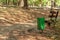 Trash can in forest with pathway for walking an running