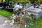 Trash container overflowing with used lamps, candles, artificial flowers and wreaths in the Cemetery in Poland