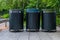 Trash containers on city street. Colorful metal containers in a row for separate garbage trash collection