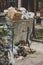 Trash dumpster being overfull with garbage in the city, vertical image.