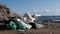 Trash, plastic, garbage on the sandy beach. Waste and recycle concept. Slow motion