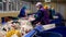 Trash workers sorting trash, garbage at a recycling plant conveyor.