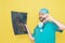 Trauma surgeon dressed in operating theatre uniform and stethoscope, reviewing X-ray with a concerned gesture, all against a