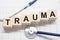 Trauma word written on wooden blocks and stethoscope on light white background