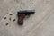 Traumatic metal gun for self defence with 9 mm bullets on a gray concrete background. top view, flat lay, copy space