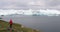 Travel adventure in Arctic landscape nature with icebergs - tourist person looking at view of Greenland icefjord -