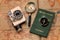 Travel, adventure with camera vintage, passport, compass and magnifier onto a retro world atlas