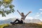 Travel, adventure and discovery by Hiking in the mountains. girl sitting on a scenic peak, smiling