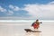 Travel adventure tourist nature photographer on Galapagos beach with Iguana