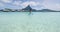 Travel Adventure woman by Stingray on SUP Paddleboard on Bora Bora, Tahiti