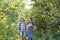 Travel, adventures, hike, tourism and nature concept - Tourist couple with cat walking in the woods