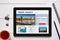 Travel agency concept on tablet screen with office objects