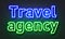 Travel agency neon sign on brick wall background.