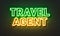 Travel agent neon sign on brick wall background.