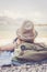 Travel around the world: compass in foreground, beautiful girl with straw hat lying on the beach in the background