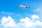 Travel background with an airplane and white clouds.