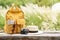 Travel backpack with traveler items on wooden bench with nature background