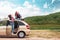 Travel banner. Caucasian mother and her teen daughter dreamy posing by a car. Copy space. The concept of freedom and