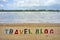 TRAVEL BLOG wood letters on the beach