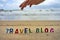 TRAVEL BLOG wood letters on the beach