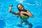 Travel blogger woman taking selfie photo with action camera in a swimming pool. Lifestyle vlogger films vlog from luxury