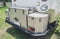 Travel camp trailer car with on the ground with grass