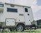 Travel camp trailer car with on the ground with grass