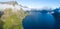 Travel concept with aerial panorama of Norwegian fiords with sea and mountains