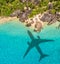 Travel concept with airplane shadow and beach