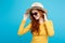 Travel concept - Close up Portrait young beautiful attractive redhair girl wtih trendy hat and sunglass smiling. Blue