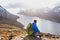 Travel concept, hiker traveler with backpack enjoying sunset landscape of Norway