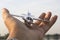 Travel concept. Male hands holding figurine of passenger plane. The plane is flying to the globe