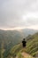 Travel concept. Man watching sunrise on Small Adams peak top in Ella, Sri Lanka