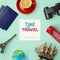 Travel concept mock up design. Objects related to travel and tourism around blank paper. View from above