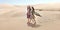 Travel concept. Two gordeous women sisters traveling in desert. Arabian Indian movie stars.