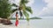 Travel concept video. French Polynesia Beach Vacation Travel. Woman in traditional pareo and Bikini relaxing on perfect