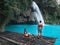 Travel couple alone on the bamboo raft of turquoise water of Kawasan Falls in Cebu