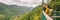 Travel couple hikers tourists taking photo with camera at view of mountain landscape in Autumn forest Parc de la Jacques