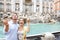 Travel couple trowing coin at Trevi Fountain, Rome