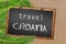 Travel Croatia palm trees and blackboard on sandy beach
