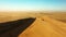 Travel, desert and sunset with drone of sand dunes for destination, freedom and summer journey. Namibia, adventure and